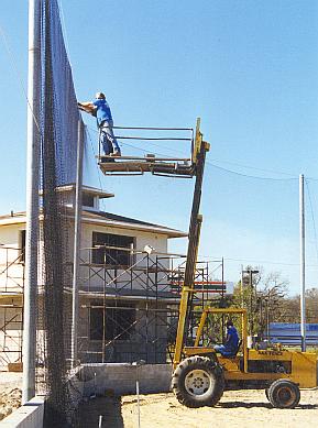 Placing the backstop protective netting.